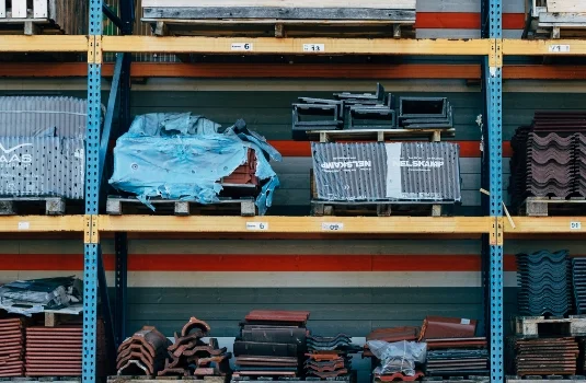 Stacked construction materials and steel components in a warehouse
