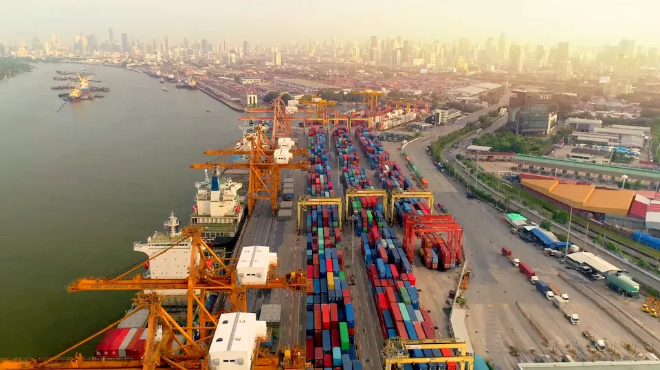 Aerial view of large container port with cranes and stacked cargo supporting global shipping and international trade