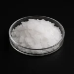 Caustic Soda 50% flakes, sodium hydroxide 50% NaOH, CAS1310-73-2 white flakes in a petri dish