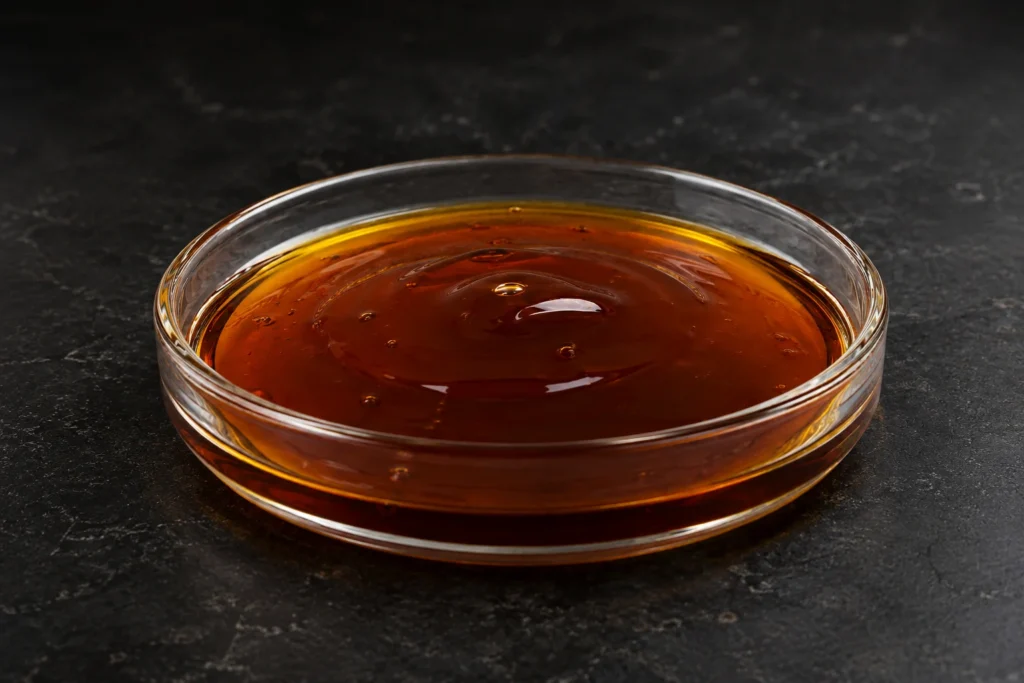 DDBSA; Dodecylbenzenesulfonic Acid; C₁₈H₃₀O₃S, CAS 27176-87-0 brown viscous liquid in a petri dish