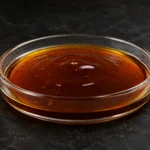 DDBSA; Dodecylbenzenesulfonic Acid; C₁₈H₃₀O₃S, CAS 27176-87-0 brown viscous liquid in a petri dish