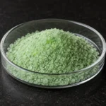 Ferrous Sulfate Heptahydrate, Green Vitriol, FeSO₄·7H₂O, CAS 7782-63-0 green crystalline granules in a petri dish